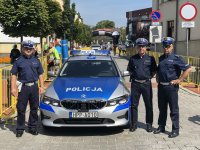 radiowóz oznakowany BMW a przy nim policjanci